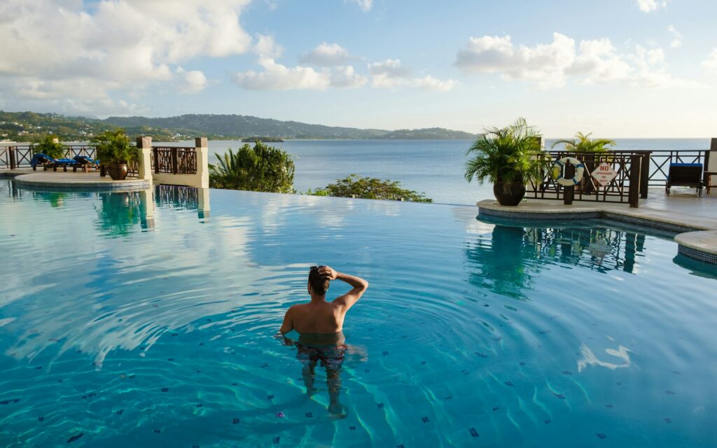 Young men in swim short at Saint Lucia Caribean, men at infinity pool during sunset